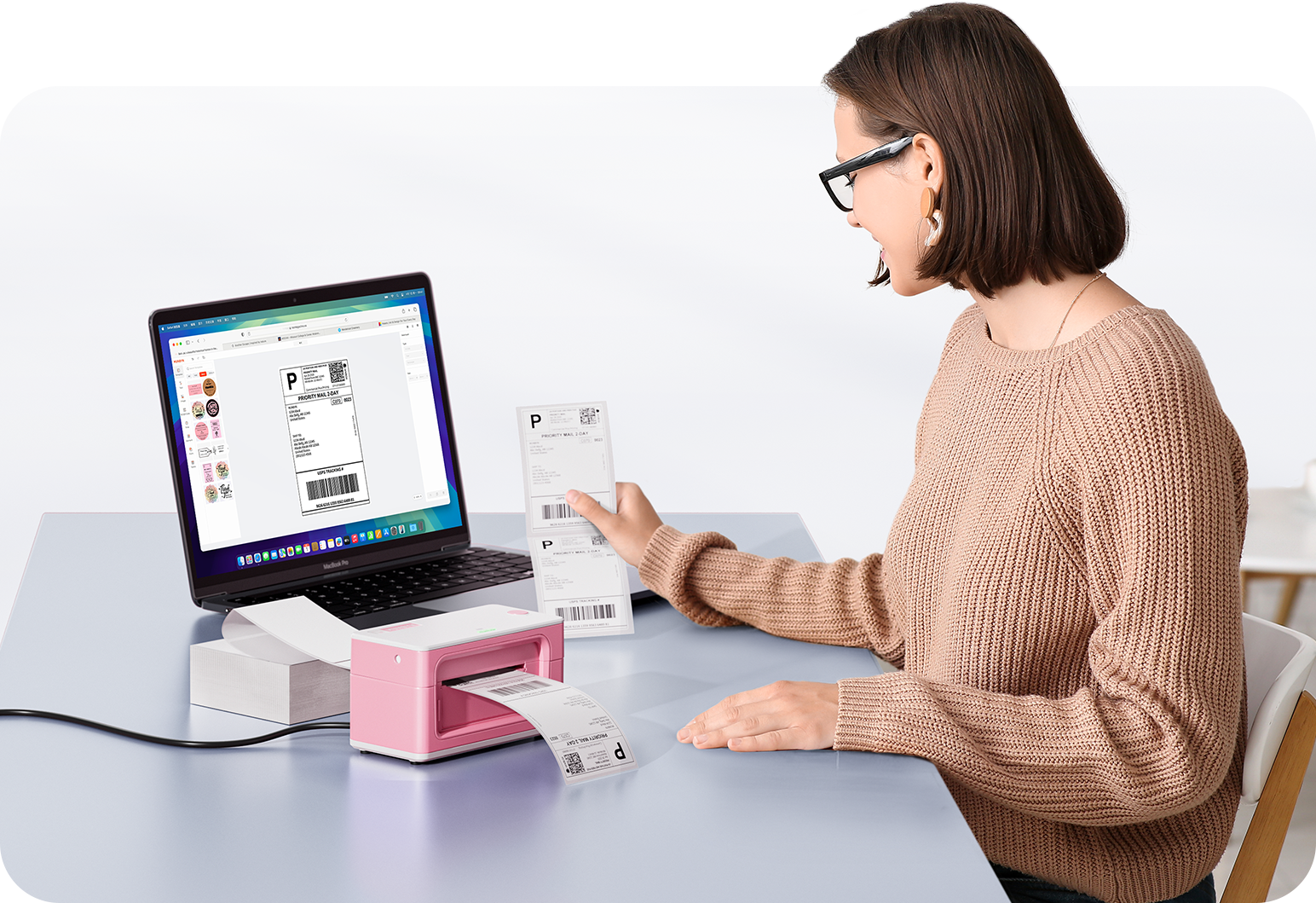 Woman using a laptop with a barcode scanner on a desk