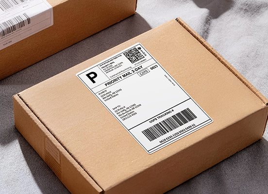 Cardboard box with a shipping label on a gray surface