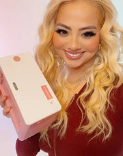Woman holding a pink thermal printer from MUNBYN