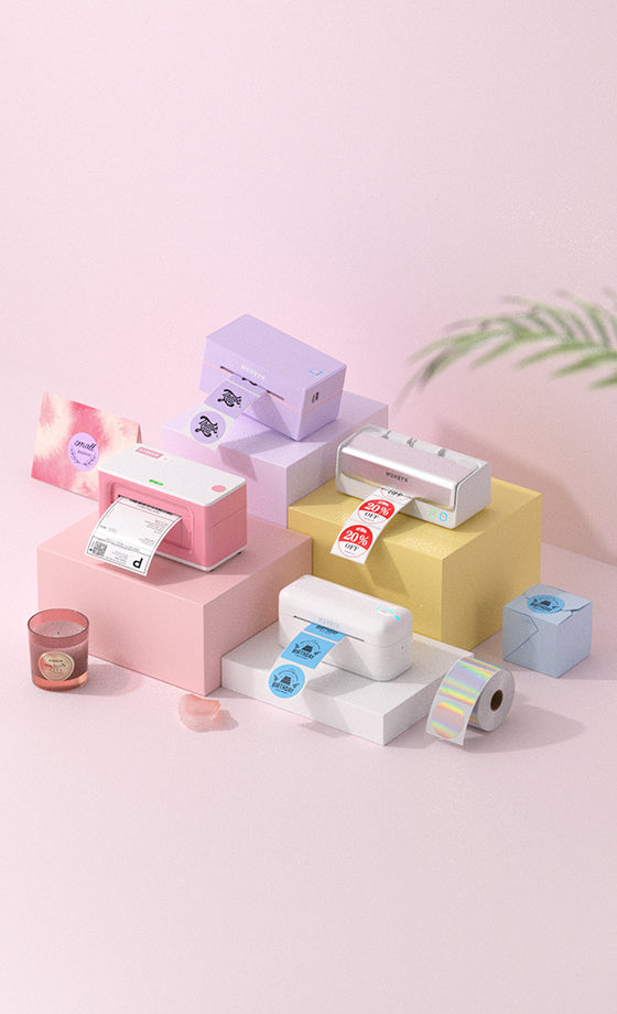 Colorful label printers and supplies on a light pink background