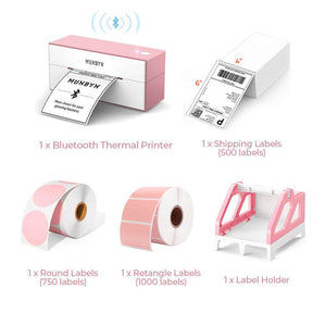 The pink Bluetooth printer kit has a pink Bluetooth shipping label printer, a roll of round labels, a stack of fanfold shipping labels, a roll of rectangular labels and a pink label roll holder.