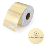 Close-up of 2-inch gold MUNBYN label printer paper sheets with shiny gold labels on white backing paper.